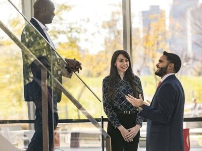 Three professionals speaking outside the classroom