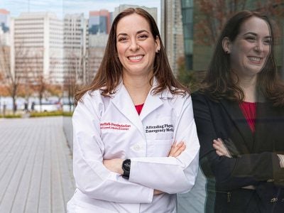 A master's in healthcare management graduate stands outside Weill Cornell Medicine
