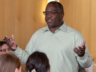 Senior Lecturer Doug Miller speaks to students at the 2024 Nolan Faculty Cooking Throw Down.