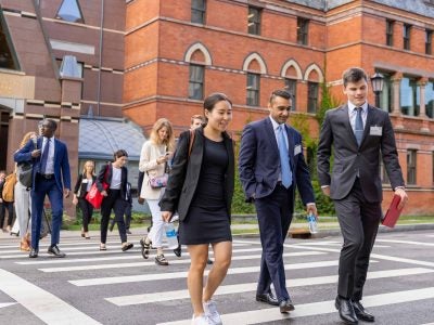 MBA Students walking across Feeney Way after leaving Sage Hall