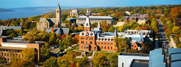 Aerial of campus sage and clock tower with Cayuga Lake in the left background