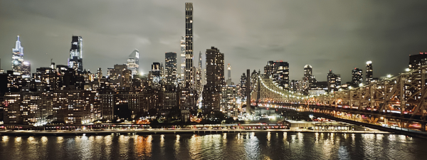 New York City scape and river view at night. From Roosevelt Island