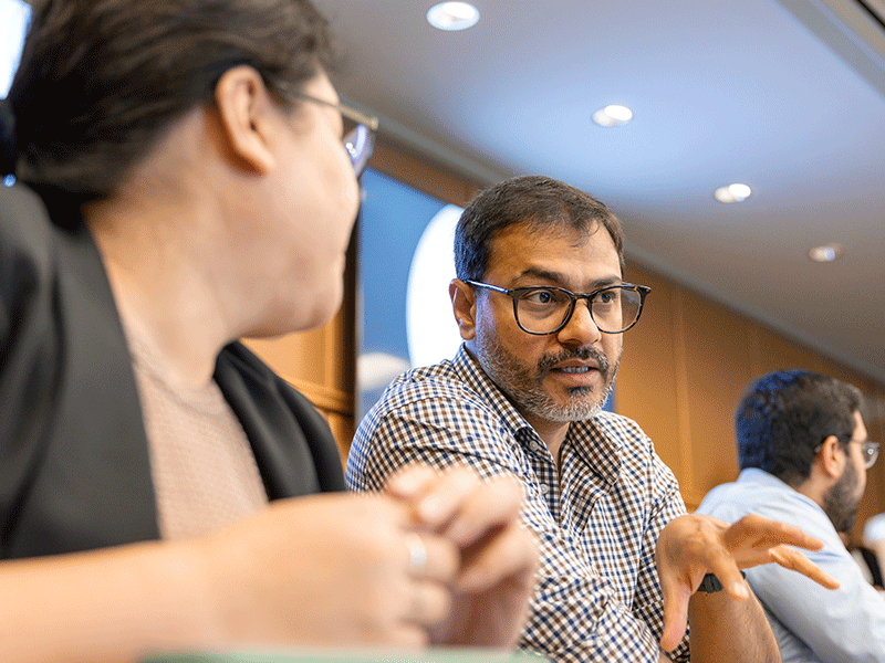 Classroom for healthcare leadership class, male with glasses speaking