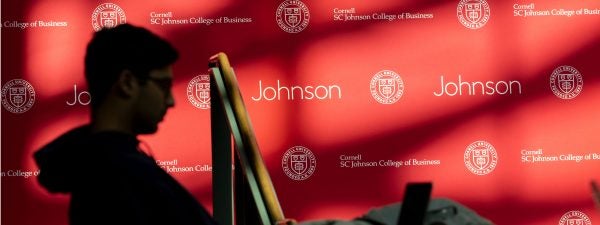 student studying next to Johnson banner