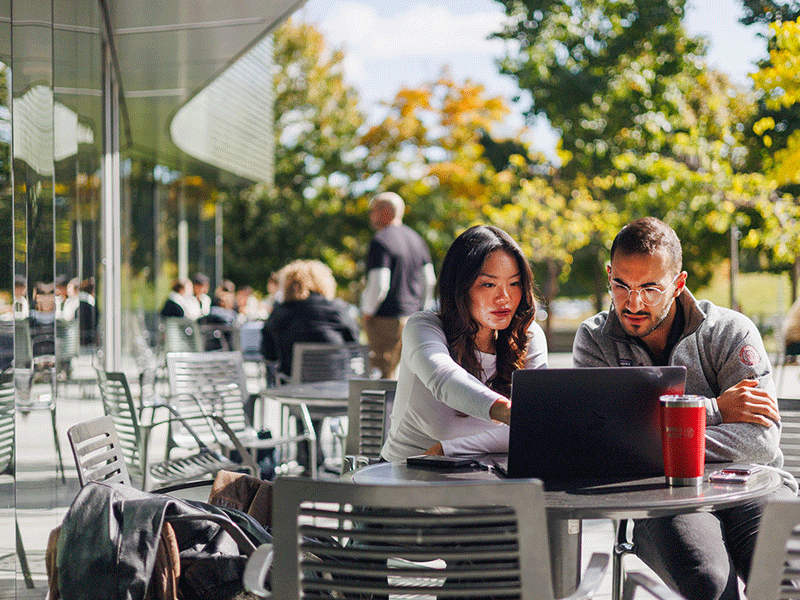 metro-NY-students-on-tech-campus-outdoor-table.