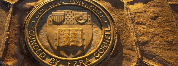 Cornell seal on sidewalk