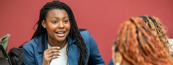A student in a suit speaks.