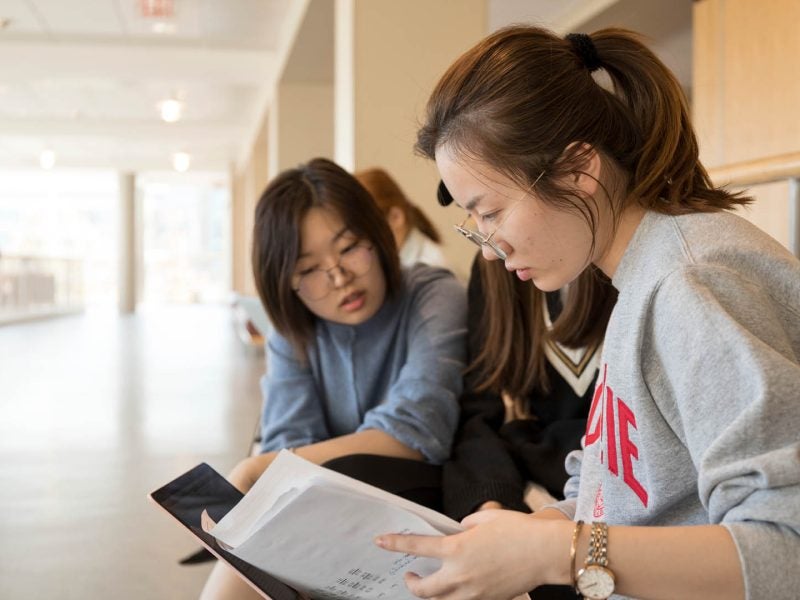 School of Hotel Administration (SHA) students working together in Statler Hall.
