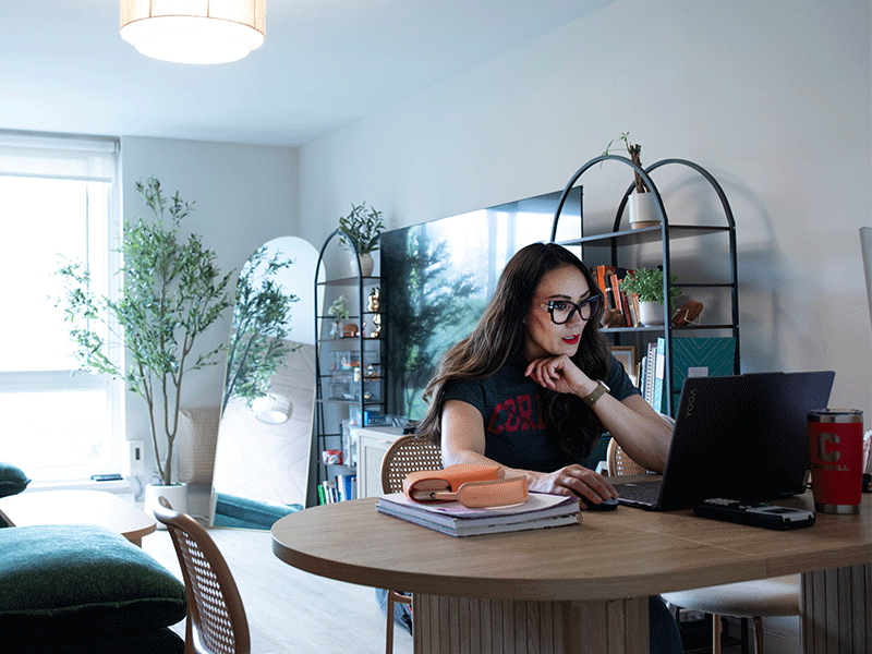 EMMH or EMBA at home learning setting, woman at her home with notebook coffee listening and interacting with online class.