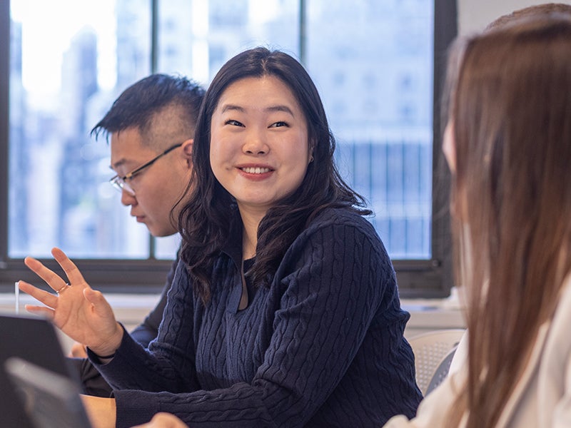 Graduate students participate in a class discussion in a New York City classroom as part of Cornell's real estate program.