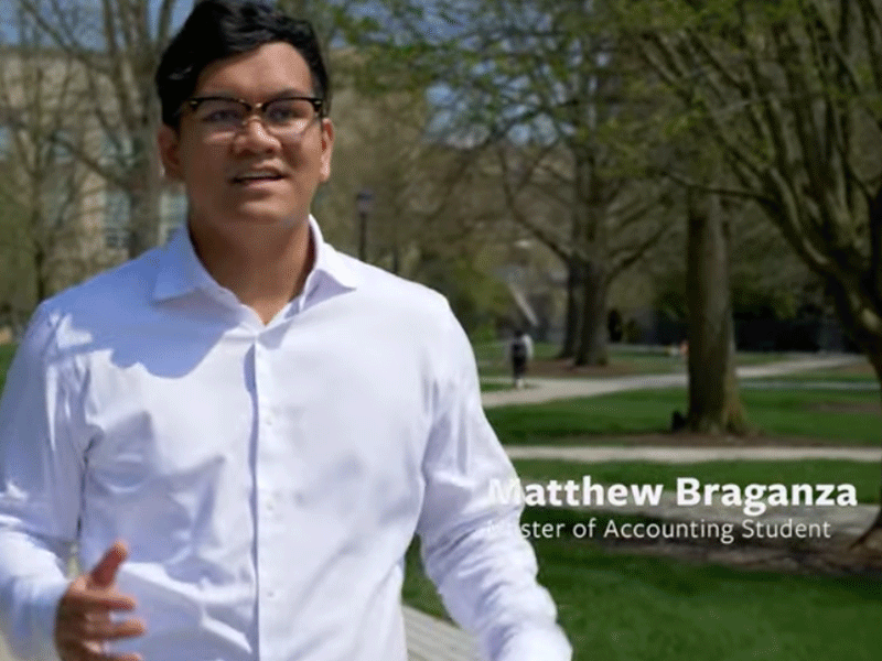 Matthew-Bragnazia-MPS-Acct-student walking to screen video player.