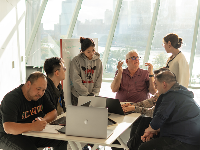 Class at CU Tech faculty in middle Manhattan in background across river