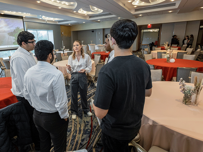 MMH ballroom setting giving direction to student staff at HEC