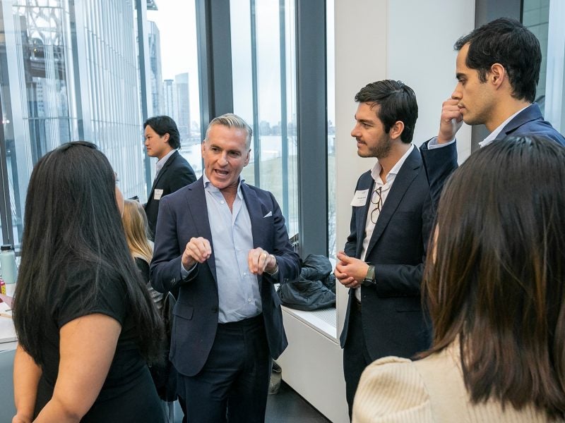 A group of people talking at an event.