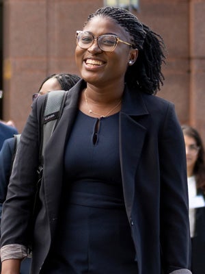 Female MBA Student in front of Sage Hall