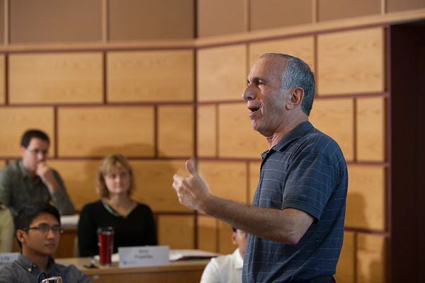 Bob Libby speaks in front of a classroom of students.