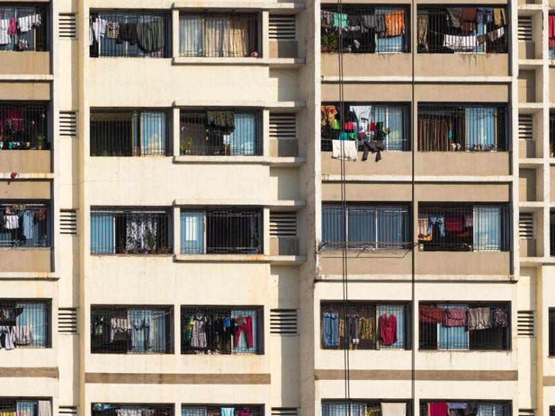 An apartment complex with laundry hanging in its balconies