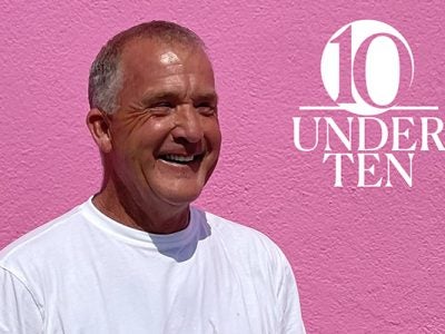 head and torso shot of Bill Dully on a bright pink background next to the 10 Under 10 graphic identifier