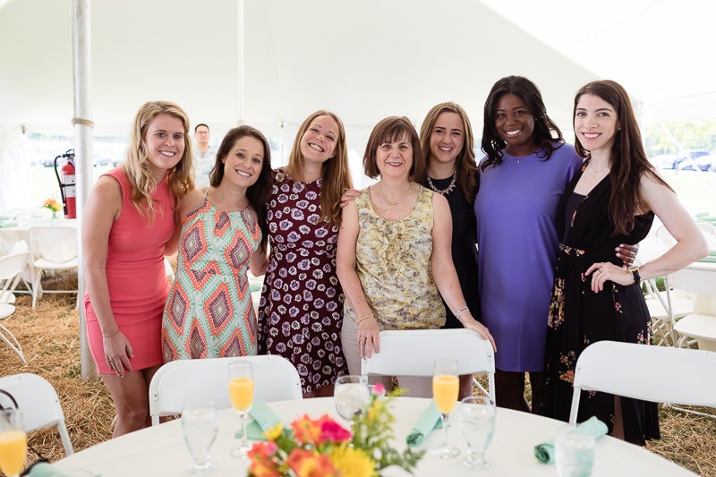 Photo of women standing behind a table