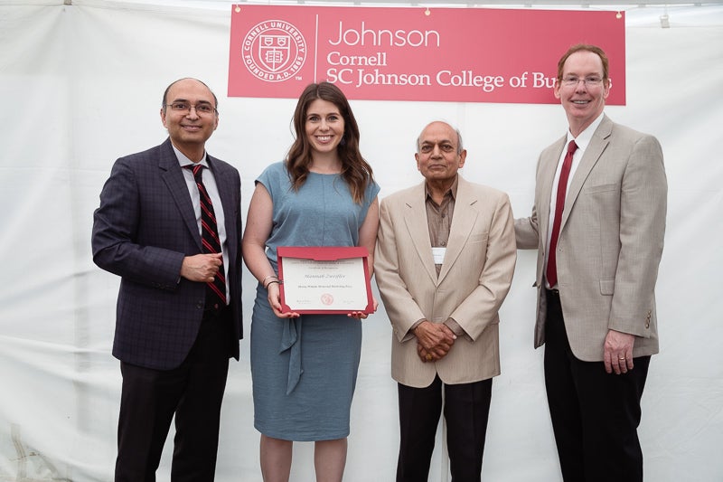 Photo of administrators and Hannah holding a certificate