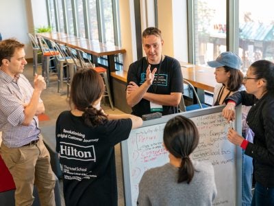 Robert Gregor chats with students at the Hilton Hospitality Hackathon, Leland C. and Mary M. Pillsbury Institute for Hospitality Entrepreneurship, Cornell University.