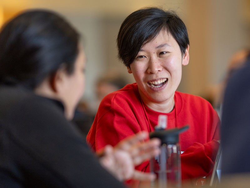 Student speaking, laughing with other student
