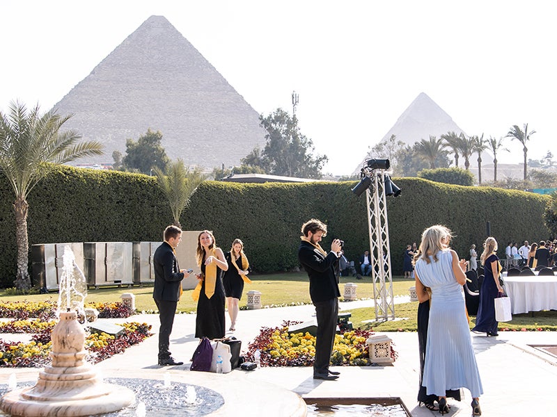 Cornell CEMS students pose for a group photo in front of the Pyramids of Giza during the CEMS International Graduation in Cairo, Egypt.