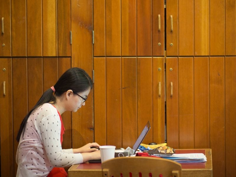 A woman works on her laptop.