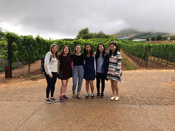 Photo of students standing outdoors in a field