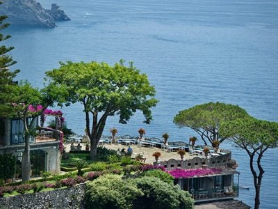 stone terrace and gardens of a hotel overlooking the sea on the Amalfi Coast of Italy.