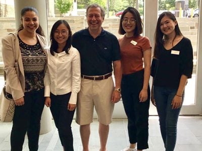 Photo of Aida Scarpati; Tiang Xiao; Coach Ed Evans ’74 , MBA ’75, VP and chief human resources officer at Four Seasons Hotels and Resorts; Yiting Wang; and Alice Wu.