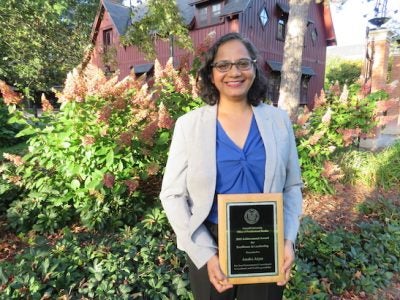 Anaka Aiyar holding her award
