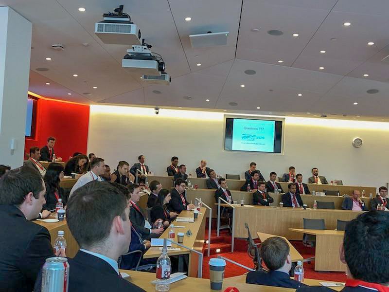 Photo of a group of people listening to speakers in a classroom