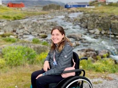 Image of Nina Bachich in a wheelchair during one of her travels.