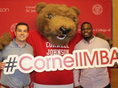 Cornell MBA students with Touchdown the bear