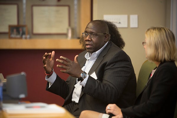 Photo of John Bonhomme, MBA &rsquo;07, speaks at the 2015 Johnson Means Business event and Diversity Symposium for the Diversity in Finance panel