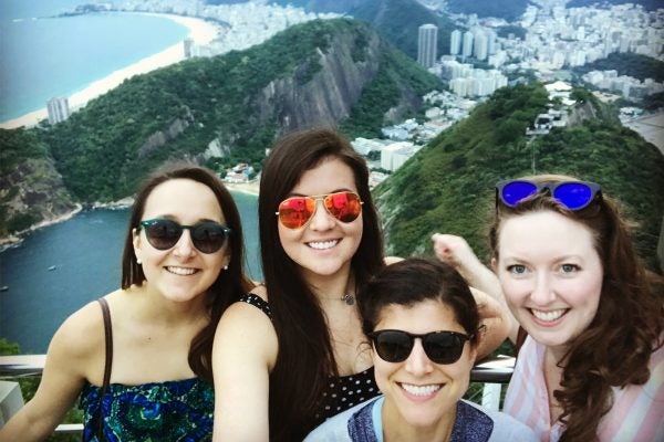 Four women with Brazil in the background