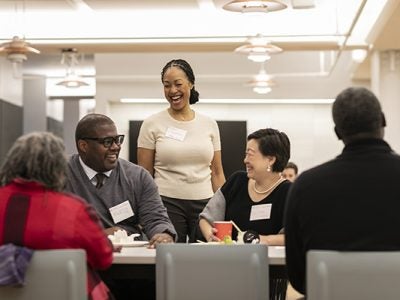 A group of professional men and women engaged in conversation
