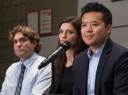 Four Cornell MBA students on stage in business casual attire