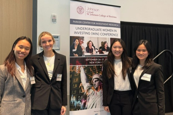 Grace Ou &lsquo;27, Lucille Ley &rsquo;27, Amber Li &lsquo;27, and Victoria Gong &lsquo;25 pose by the 2024 Undergraduate Women in Investing Conference banner.