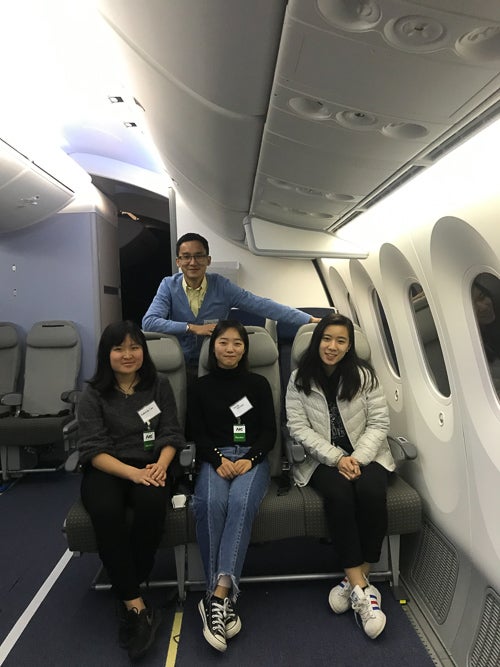 Students sitting in an airplane cabin model