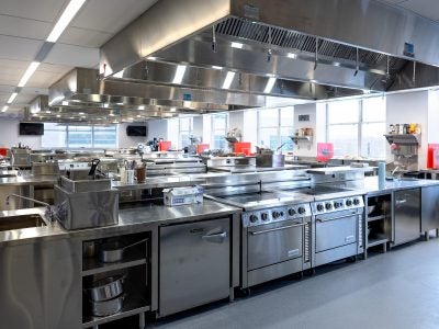 A split-screen photo of the Grailer Food Lab, contrasting the space's appearance under construction and completed.
