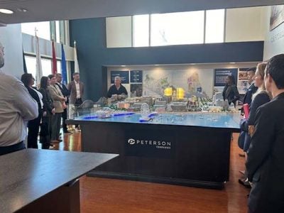 Participants gather around National Harbor architectural model to learn more about project developments