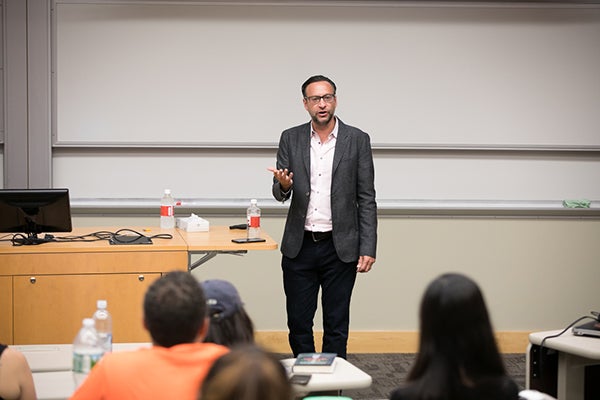 Photo of Damian Mogavero speaking to students in a Hotel School class