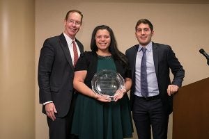 Photo of Dean Mark Nelson and Andr&eacute;s Quintanilla, MBA &rsquo;18, present Adrienne Martinez &rsquo;01, MBA &rsquo;08 (center), with the Carlos R. Quintanilla Distinguished Latino/Latina Alumni Award