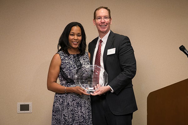 Dean Mark Nelson presents Tyeise Huntley Jones, MBA &rsquo;10, with the Wilbur Parker Distinguished Alumni Award