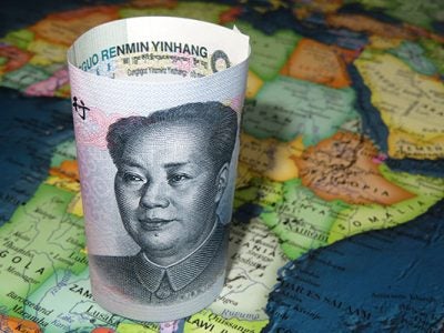 photo of CNY paper bill sitting on a map of Africa