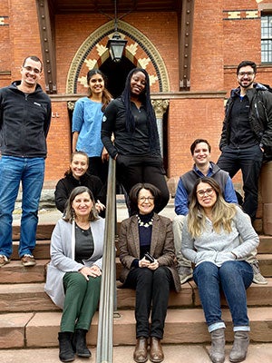 Lourdes Casanova and Anne Miroux and the Emerging Markets Institute&rsquo;s research team, photographed together on the steps of Sage Hall