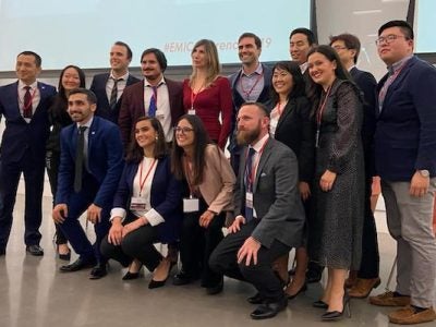 A team poses for a photo at the front of the conference space
