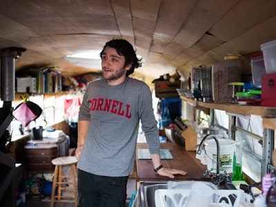 Photo of Eli Shanks ’18 in his renovated home. Image credit: Cameron Pollack, Cornell Daily Sun